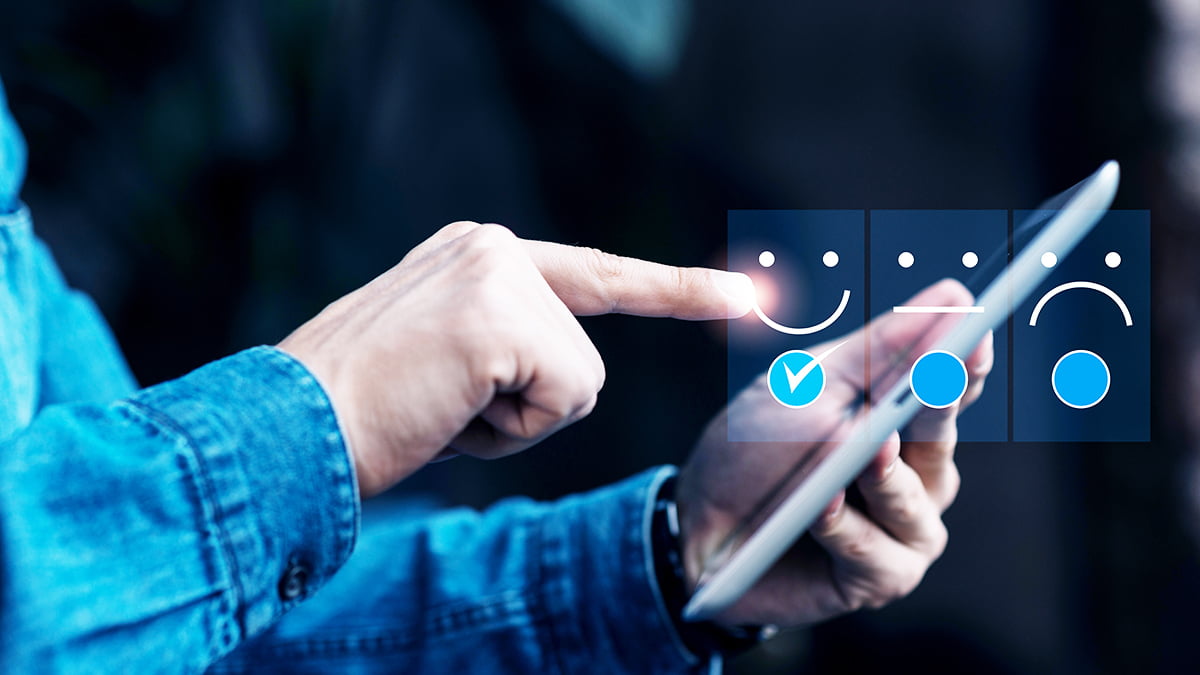 nps - consumidor selecionando reação positiva em pesquisa num tablet